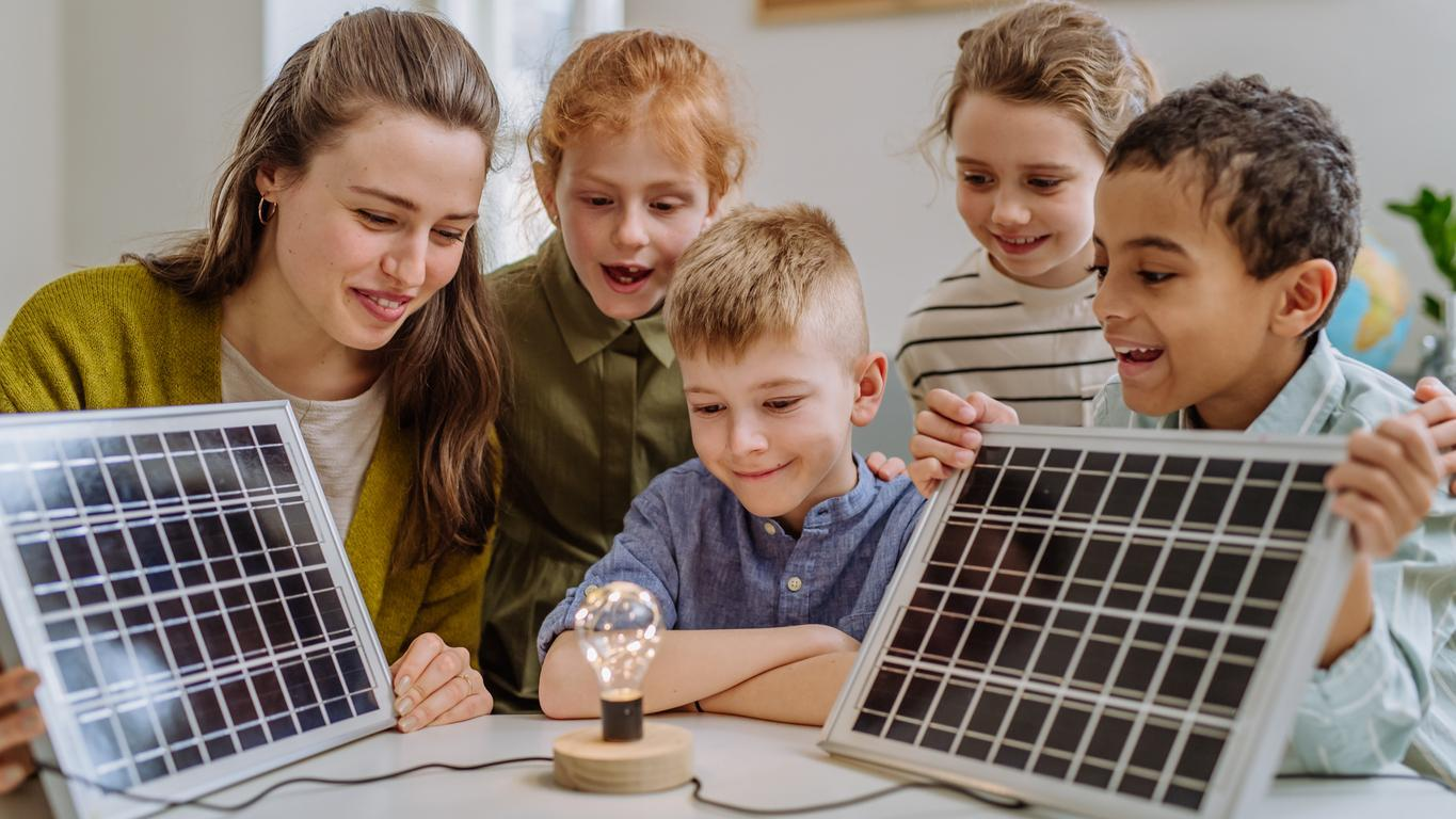 Children learning with a solar-powered device at Energize the Block
