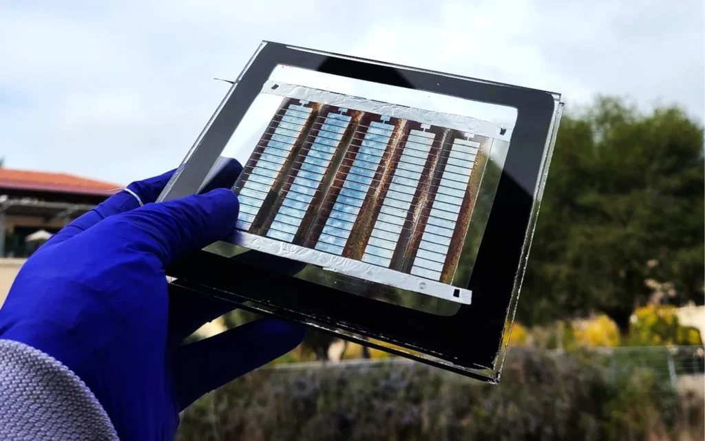 “Scientist holding advanced thin-film solar cell prototype in laboratory developing next-generation photovoltaic technology”