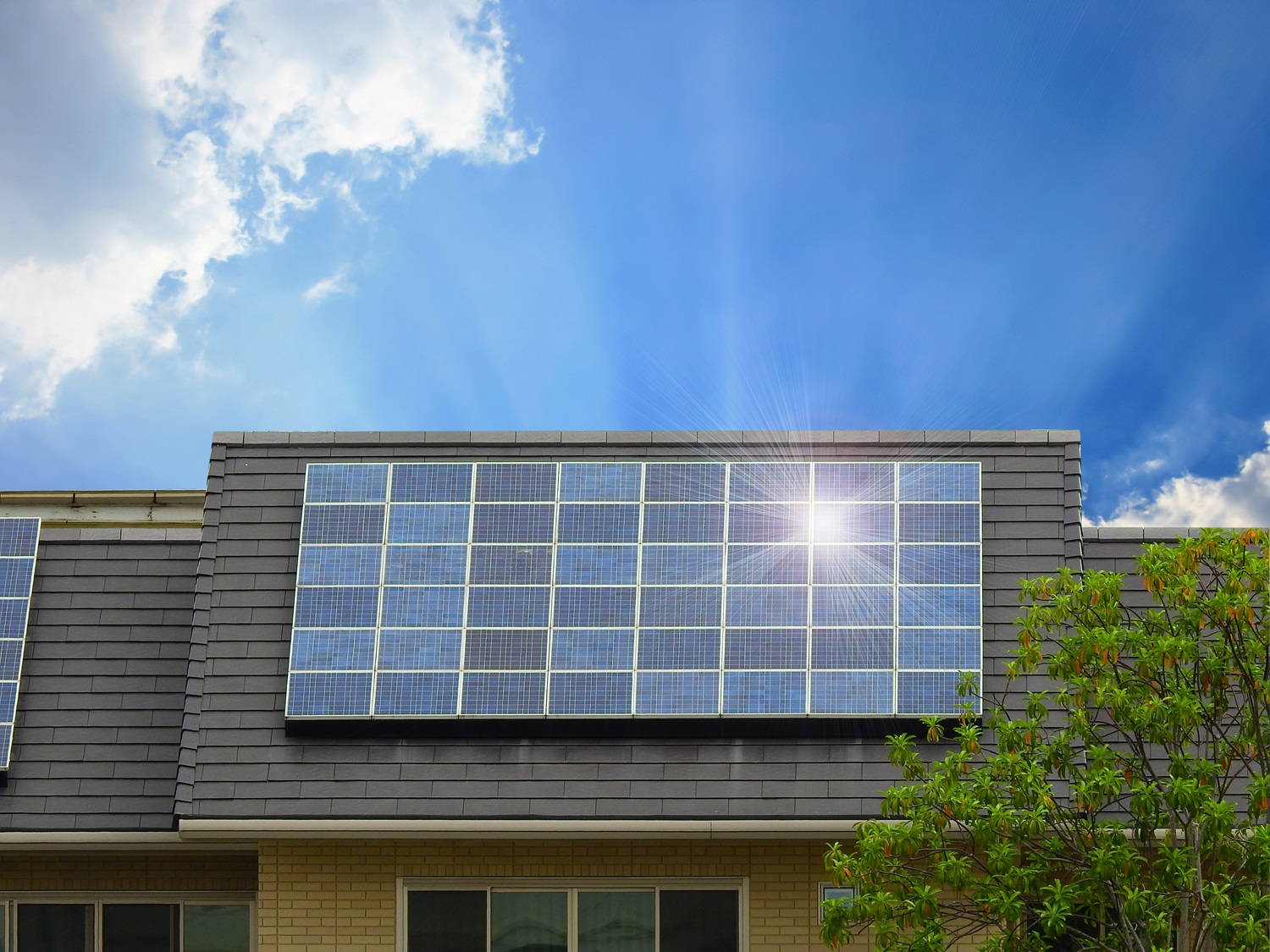 Green energy of solar cell panel on house roof in blue sky and sunlight